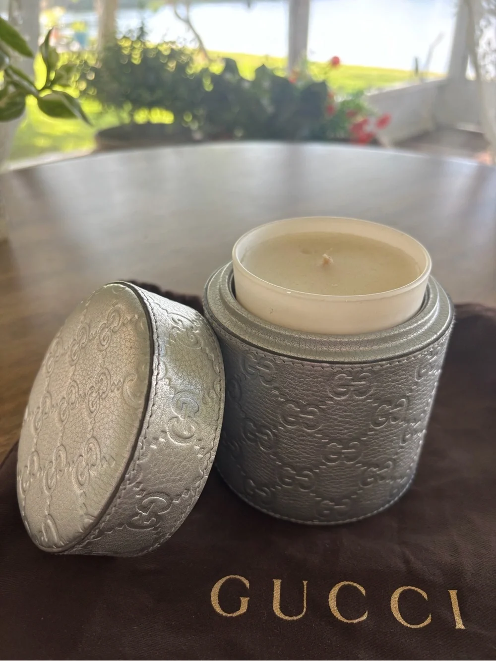 Gucci Candle Holder with lid and glass container with candle.